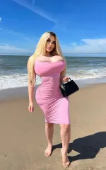 Analisa at the beach in a pink dress