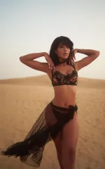 Melanie standing on top of a sand dune while rocking black lingerie 
