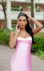Melanie standing in a pink skintight dress 